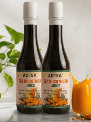 Premium ADVEA Sea Buckthorn Juice dark glass bottle featuring an elegant matte white cap with a gold rim accent. The bottle stands on a white marble slab next to a splashing glass of vibrant orange juice, fresh sea buckthorn berries, and a potted green plant on a bright, modern kitchen counter backdrop.